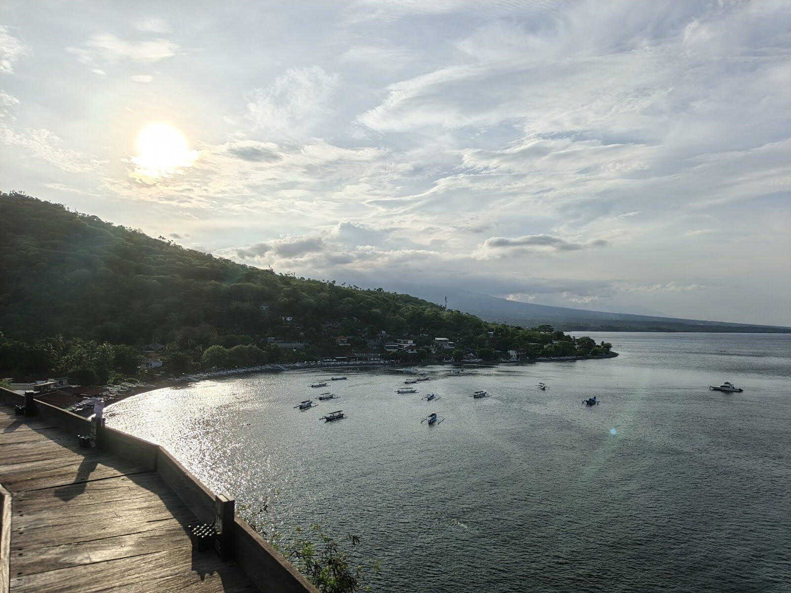 Sunrise over Amed's bay, the fishing boats moored and the sun climbing over the hills — the reason people wake early here.