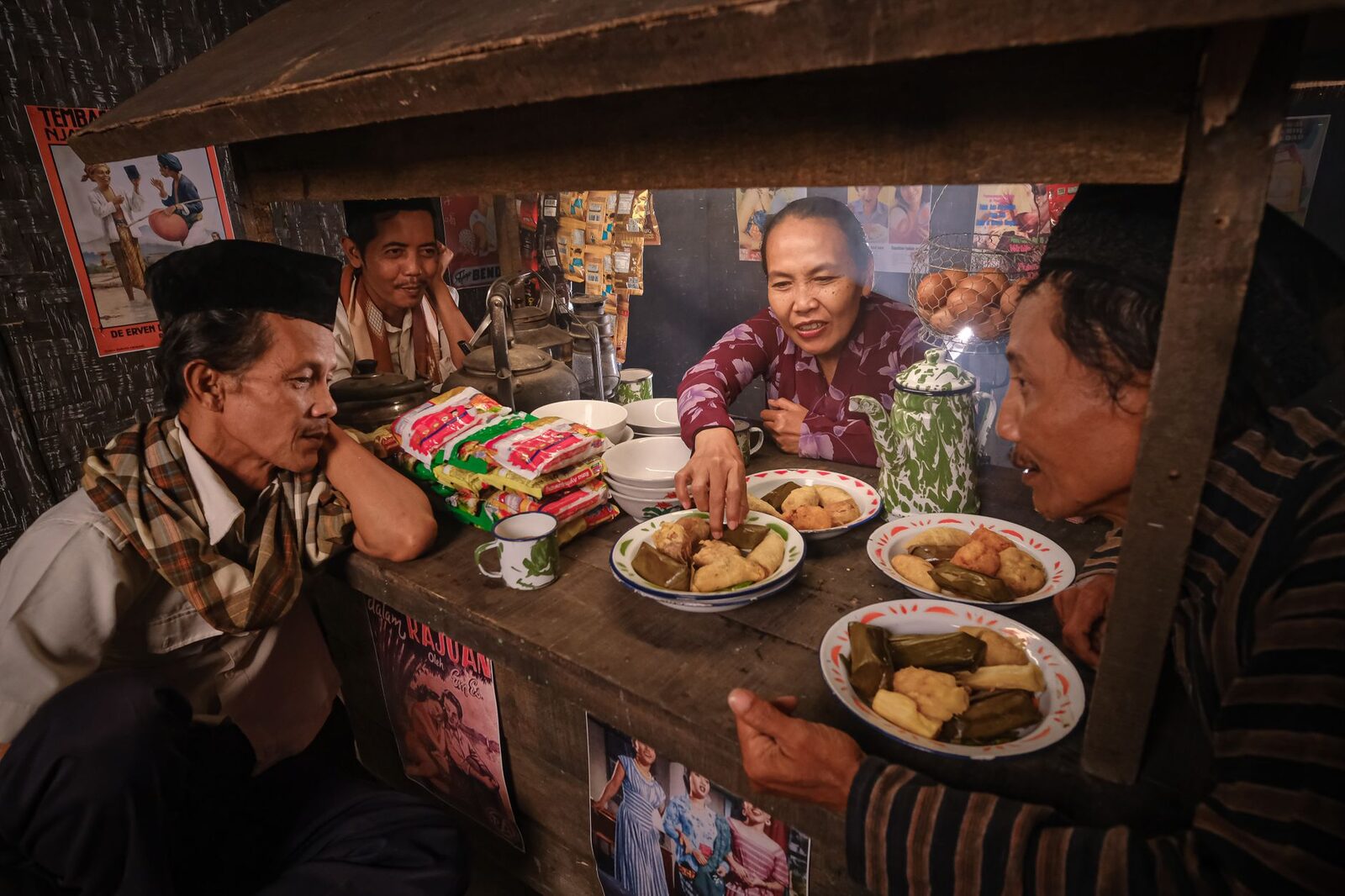 Locals eating plates of food at a warung window — where the island really feeds itself.