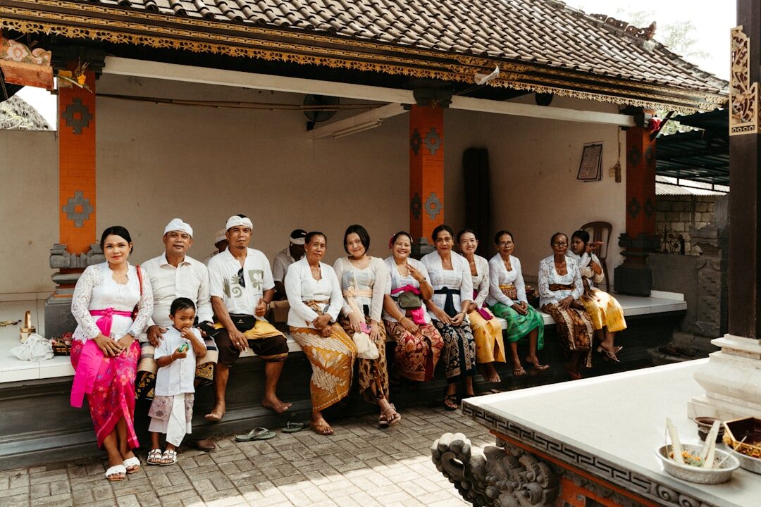 A family gathered in the temple pavilion in ceremonial dress. Tap any image for its source and licence.
