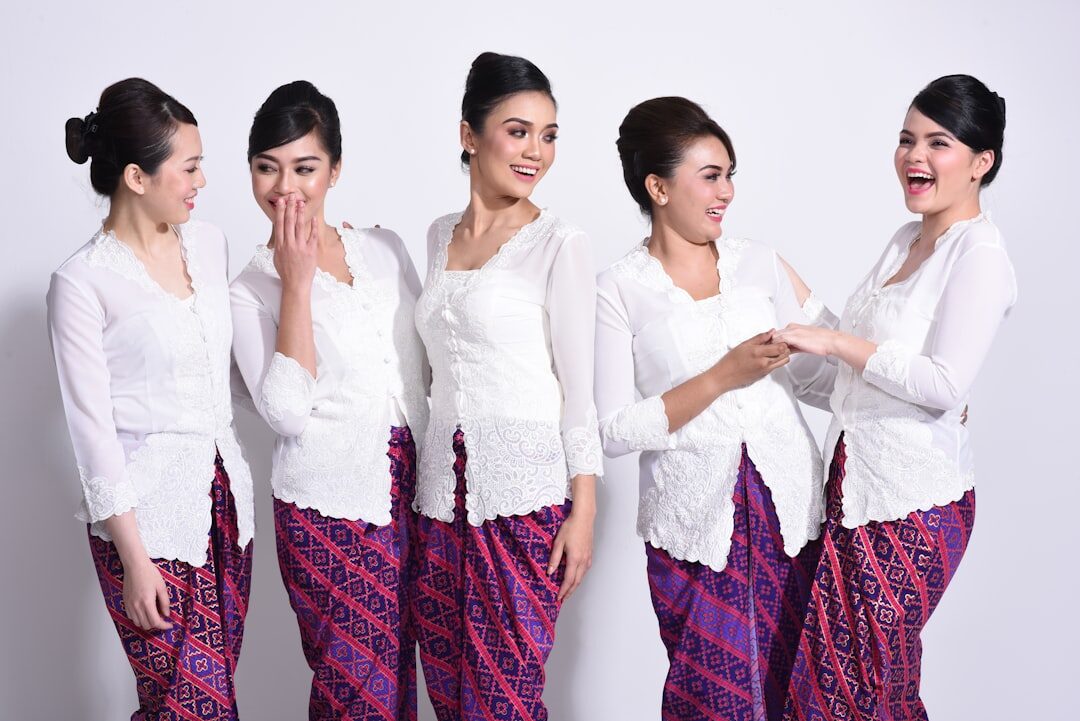 The traditional dress up close: a lace kebaya over a songket sarong. Cover up in a village, a warung or a market — a light shirt and shorts or a sarong is plenty.