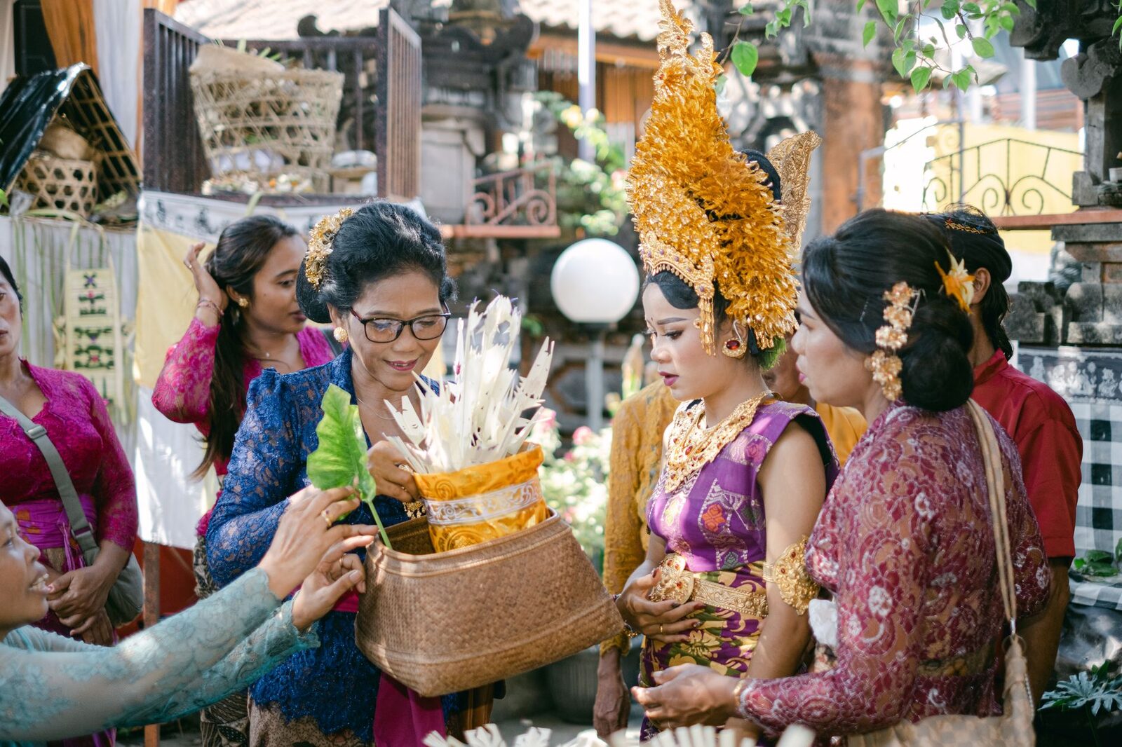 Women in kebaya at a market gathering with their offerings — everyday modesty, worn without ceremony.