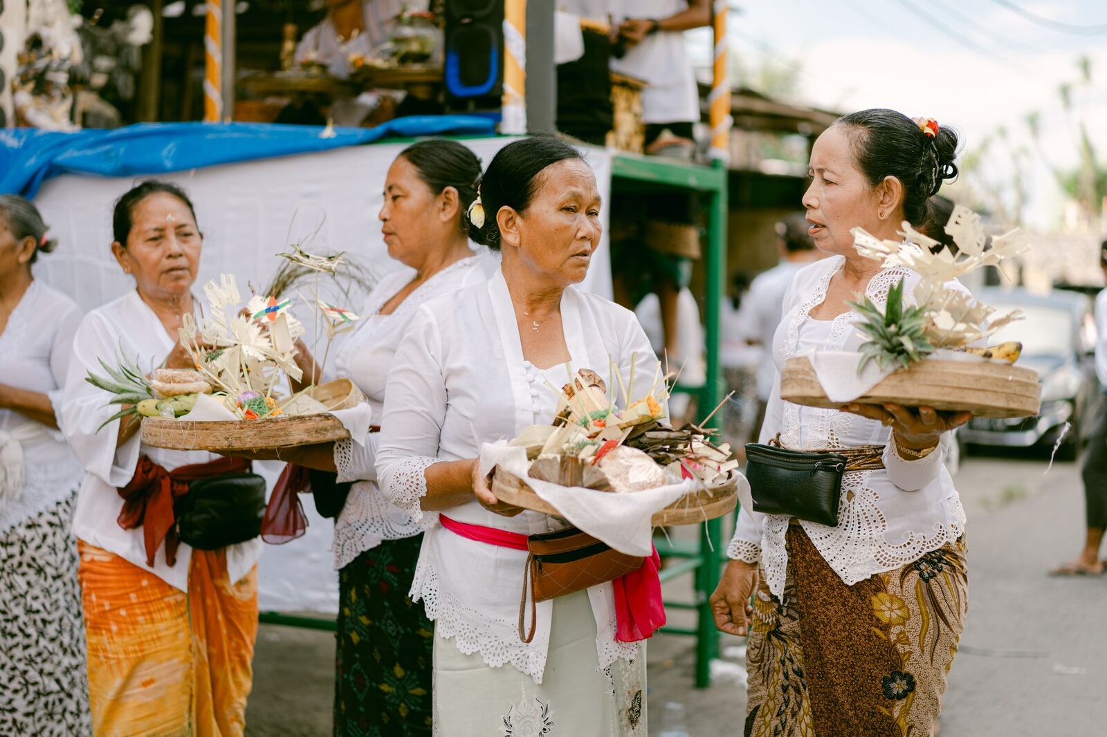 Carrying offerings through the day in full dress. Walking through town half-covered reads as disrespectful, not carefree.