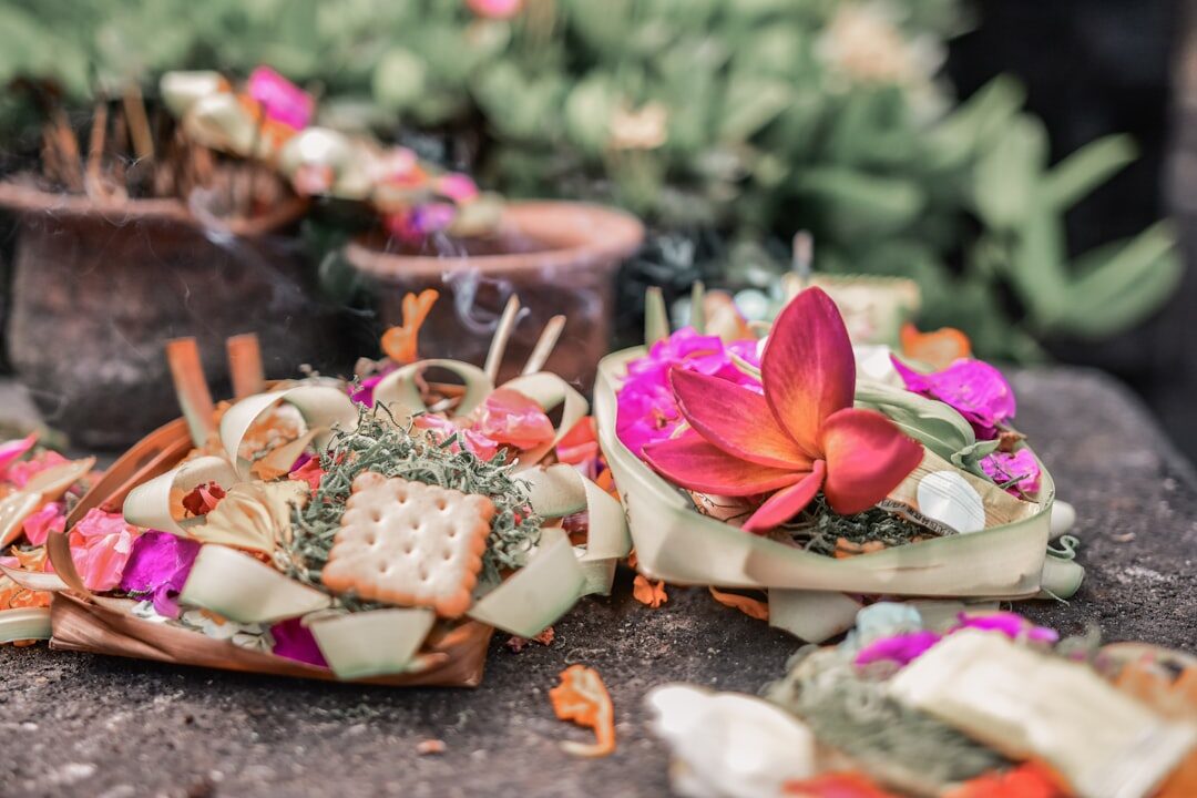 The offering close up: flowers, a wafer, a curl of petals. Never pick one up as a souvenir. Tap any image for its source and licence.