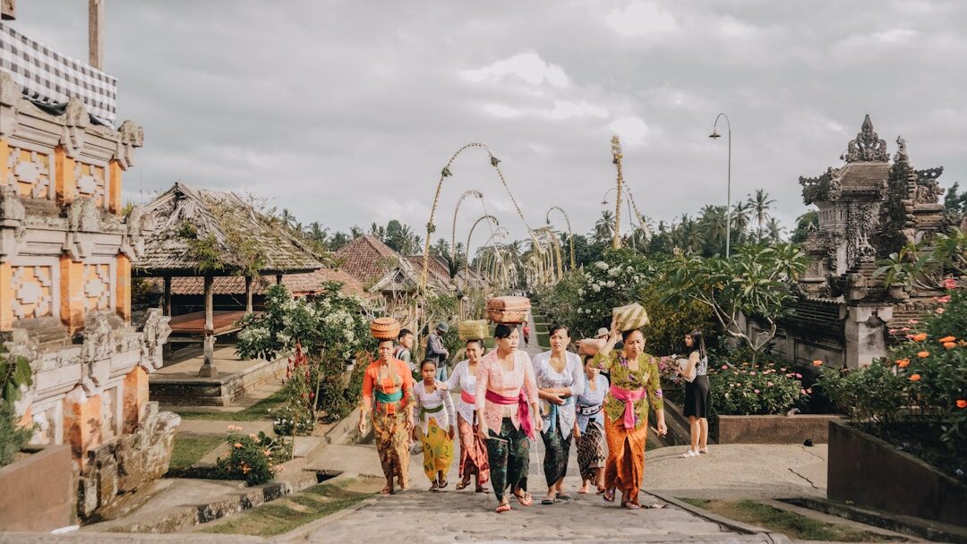 Two things get you through the gate: a sarong wrapped at the waist and a sash — the selendang — tied over it. Both are required to enter any temple.