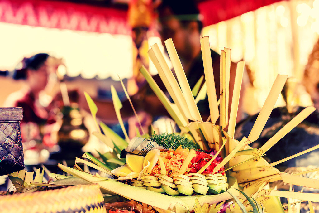 A woven palm-leaf offering close up — the everyday craft behind every ceremony.