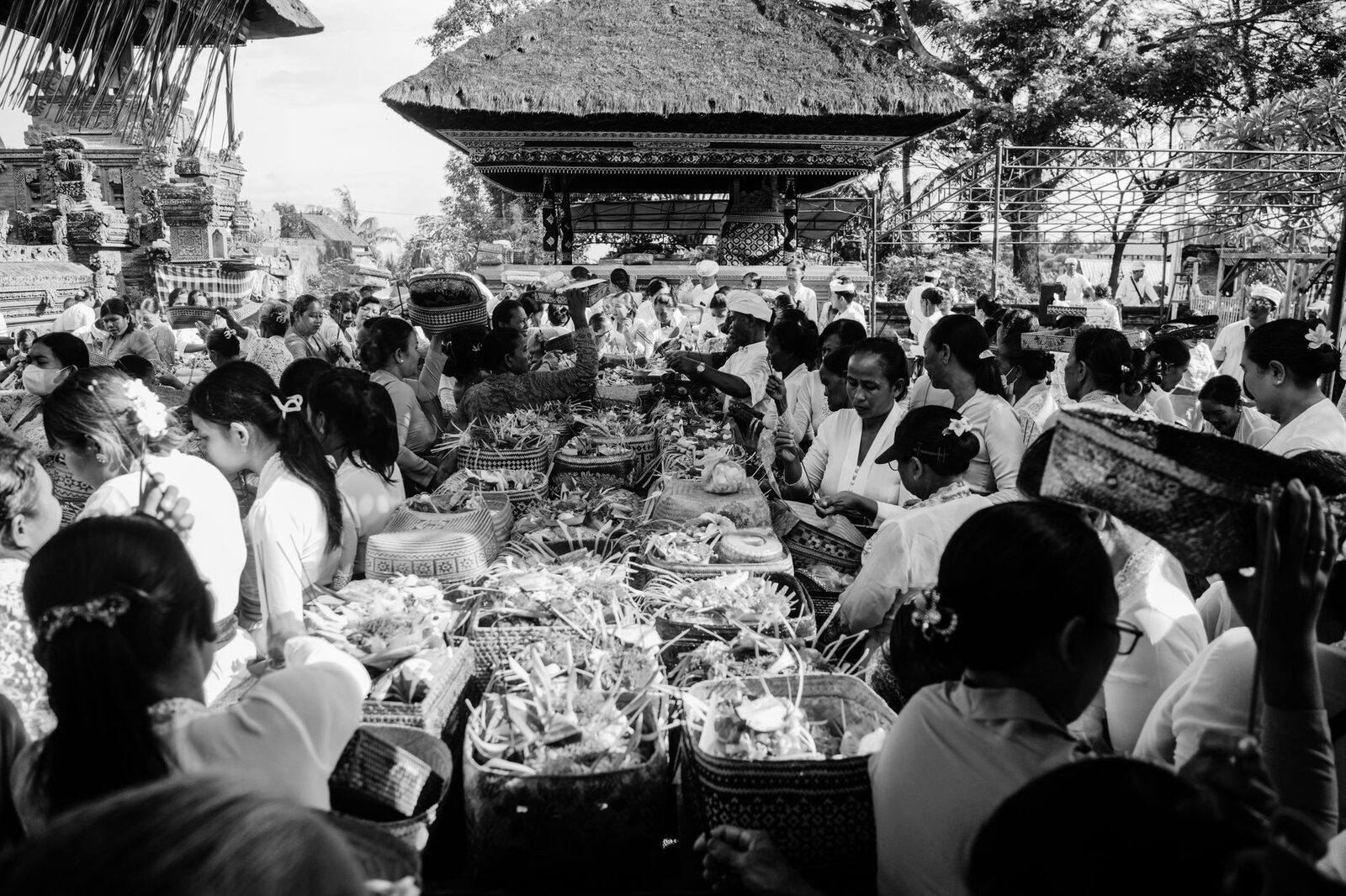 A crowd of worshippers packed together at a ceremony, seen in black and white.