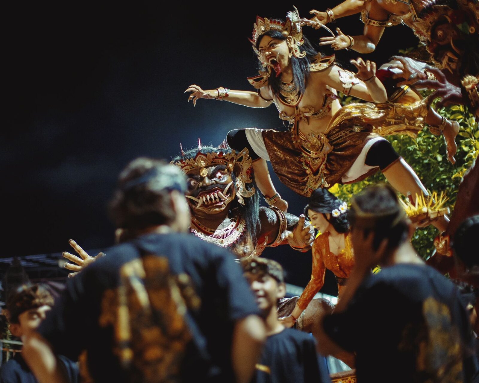 The parade after dark — torch-lit and loud, the crowd pressing in around an effigy on Nyepi eve.