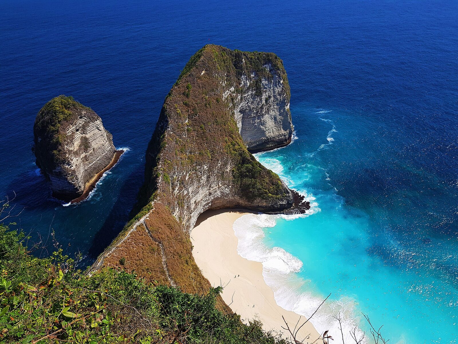 Deep ocean blue meeting the pale turquoise of the cove.