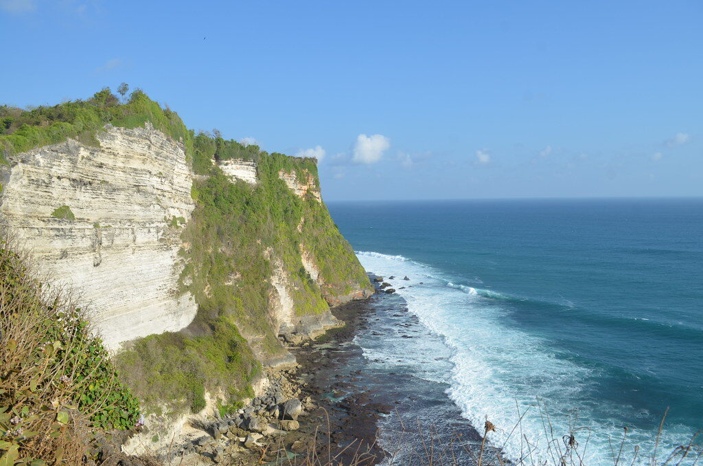 The Bukit's white limestone cliffs dropping to turquoise surf — the beachy, buzzy south where a first-taste trip should start. Settle here, slow down, and don't try to reach the far coast every day.