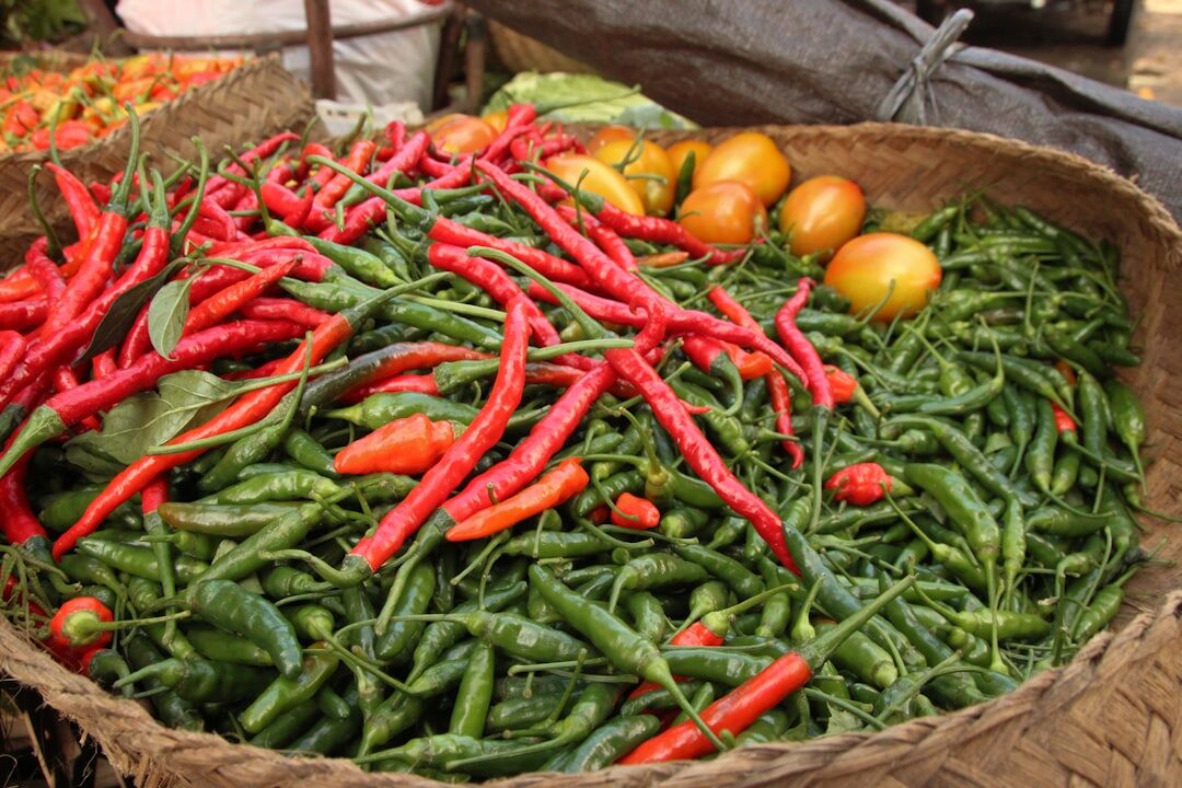 Chillies and produce heaped in a market basket. Knowing roughly what things cost is most of the battle.