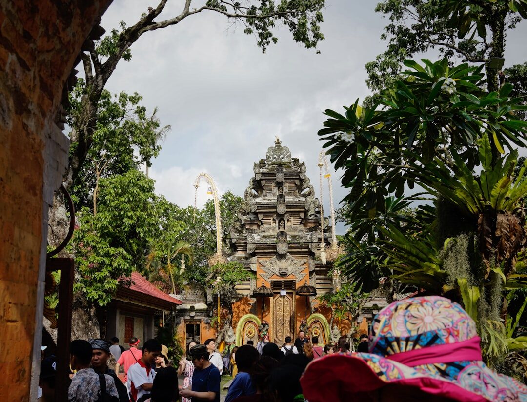 A Bali market by the temple gate — sarongs, stalls, produce, and rarely a posted price. Haggling here is expected and friendly; start well under and meet in the middle.