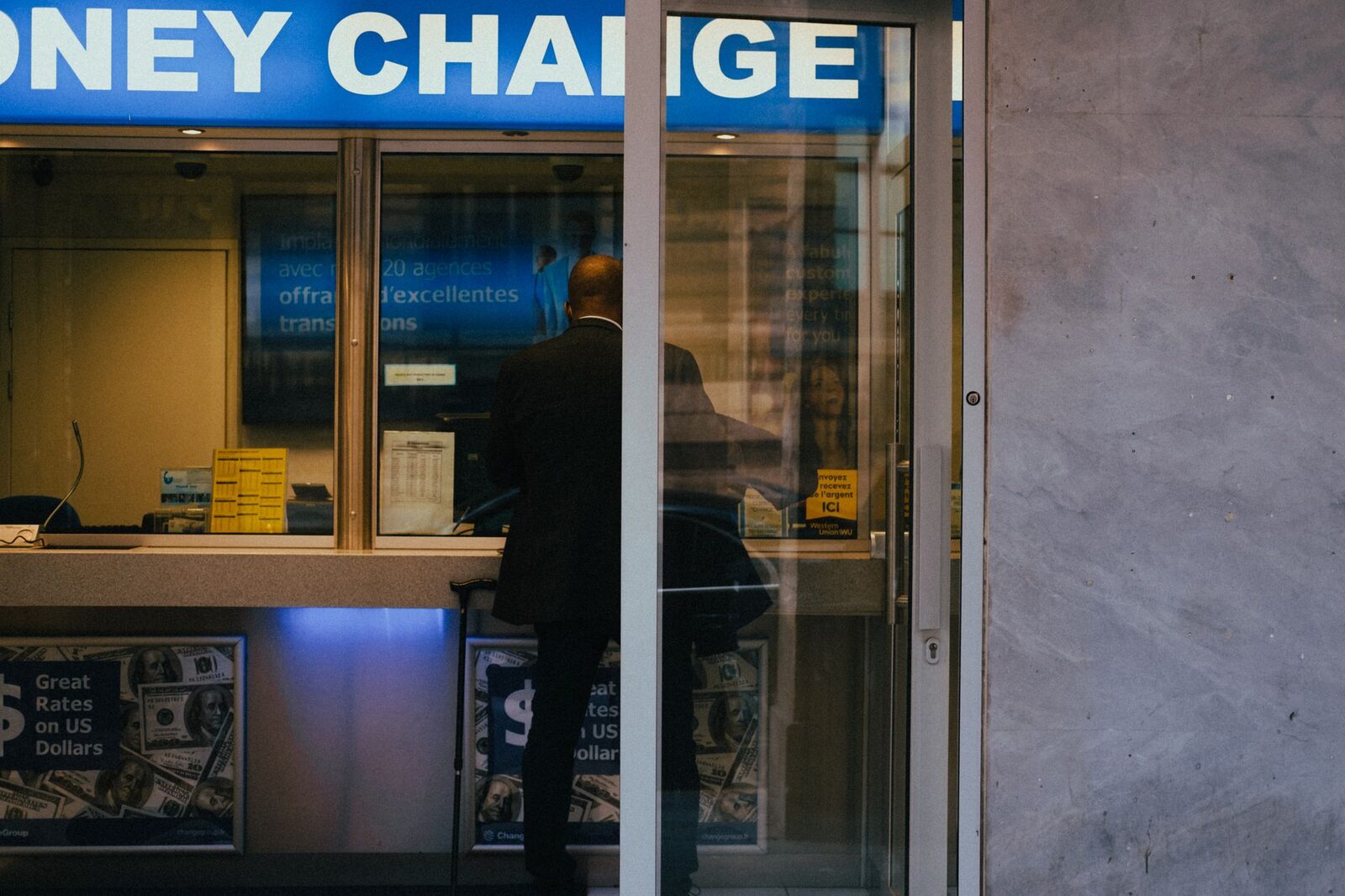 A money-changer booth of the kind you'll see down the side streets — a rate a notch better than everyone else is the bait. Count the cash yourself, and once it's in your hand it doesn't go back on their side of the counter. Illustrative; most changers are perfectly honest.
