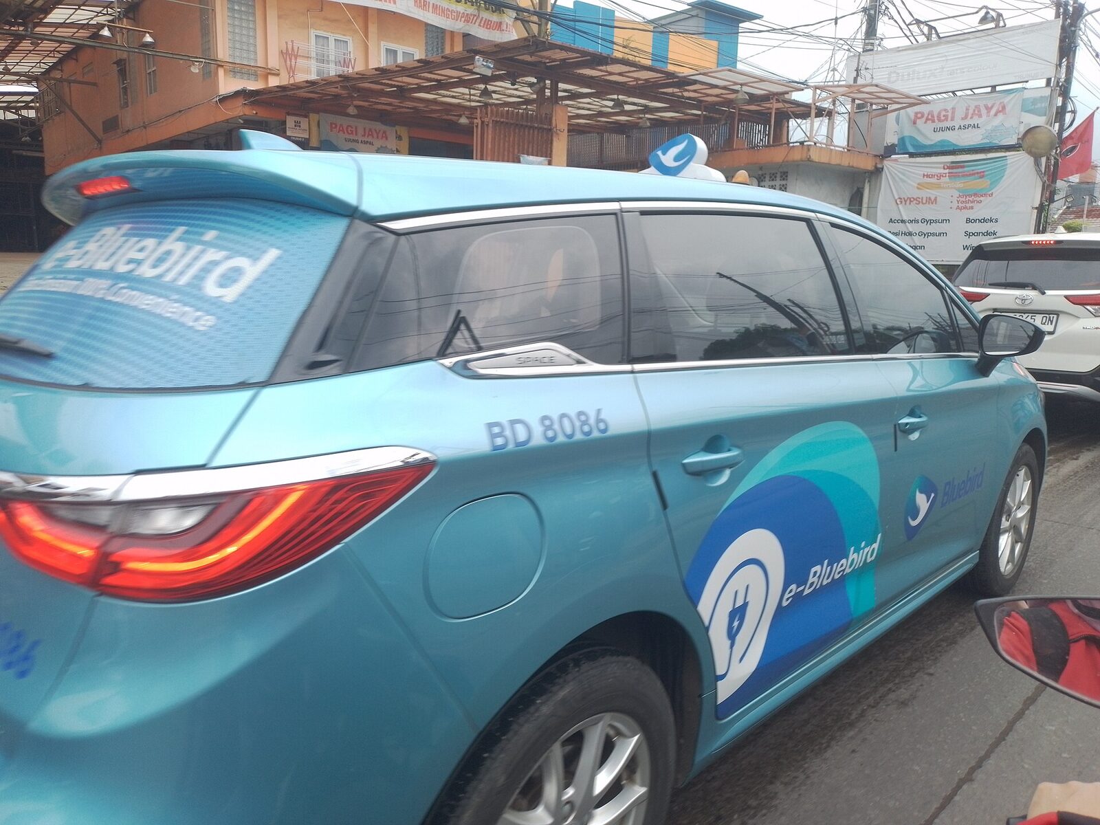 The real thing: a Blue Bird cab, bright blue with the bird logo and a driver who runs the meter without being asked. The copycats wear near-identical paint and a subtly wrong name — 'Bali Bird', 'Blue Bird Bali' — and a meter that's mysteriously broken.