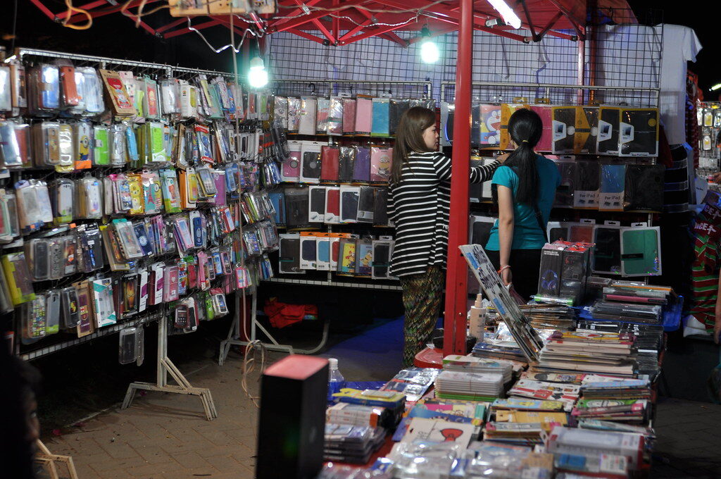 A phone-and-accessories shop like the ones all over town — buy your local SIM somewhere staffed that will register it to your passport and test it before you leave.