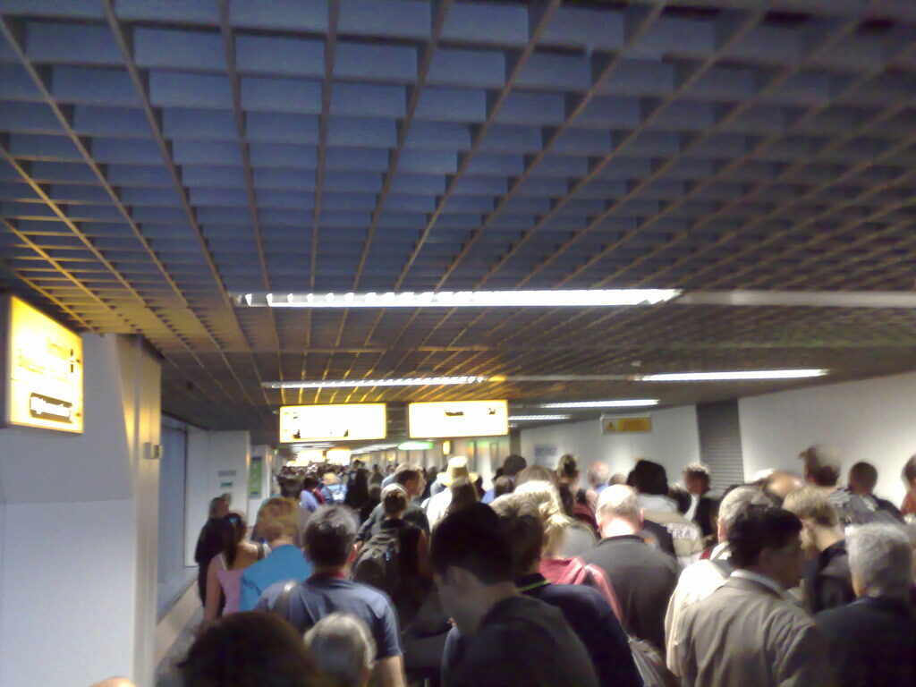 The immigration queue at Ngurah Rai after a full flight — this is the hour the e-VOA lets you skip, when a few wide-bodies land together.