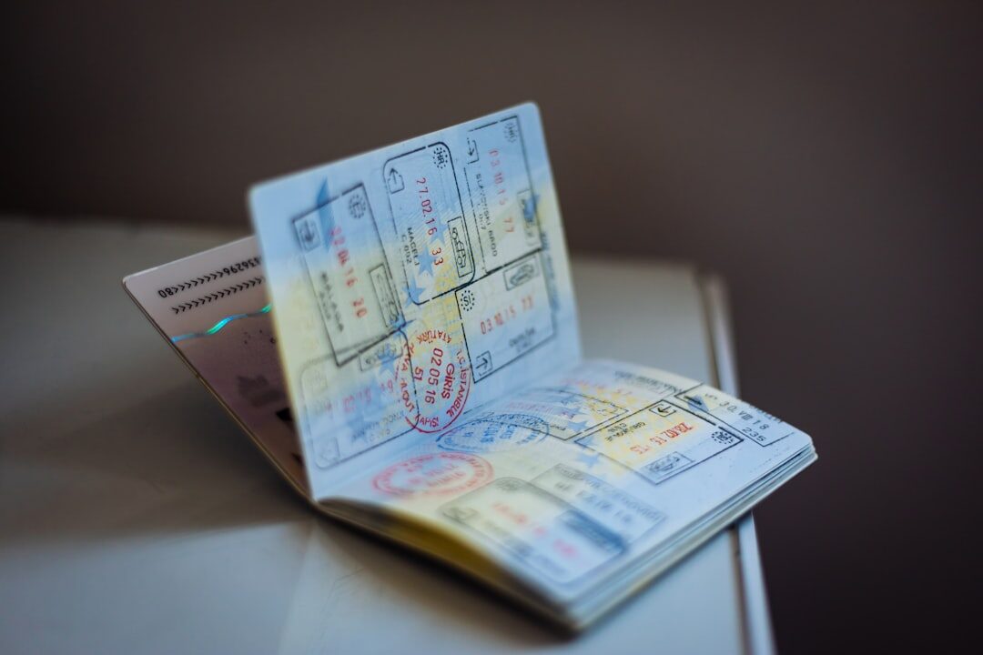 An open passport filled with entry stamps and visa stickers — the VOA is one more sticker in the book, paid for at a counter or bought online before you fly.