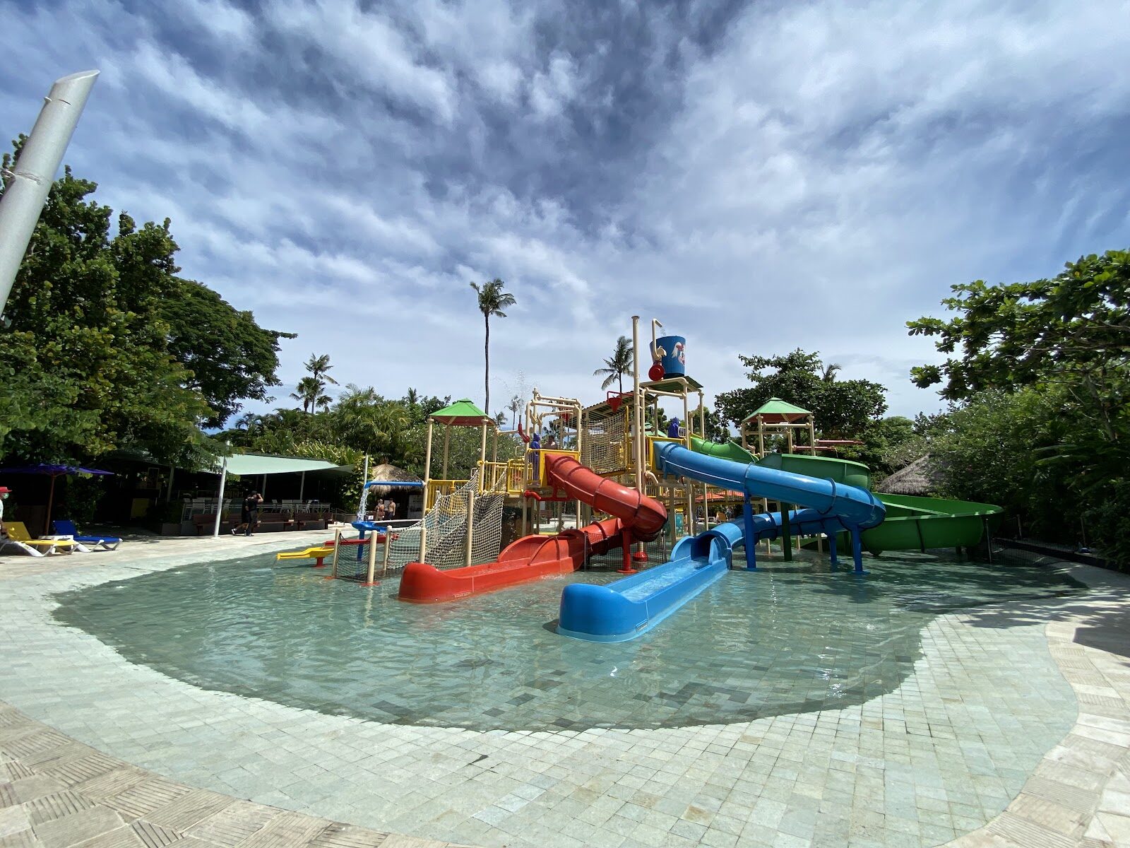 A family water park with shallow play pools and slides — built for little ones.