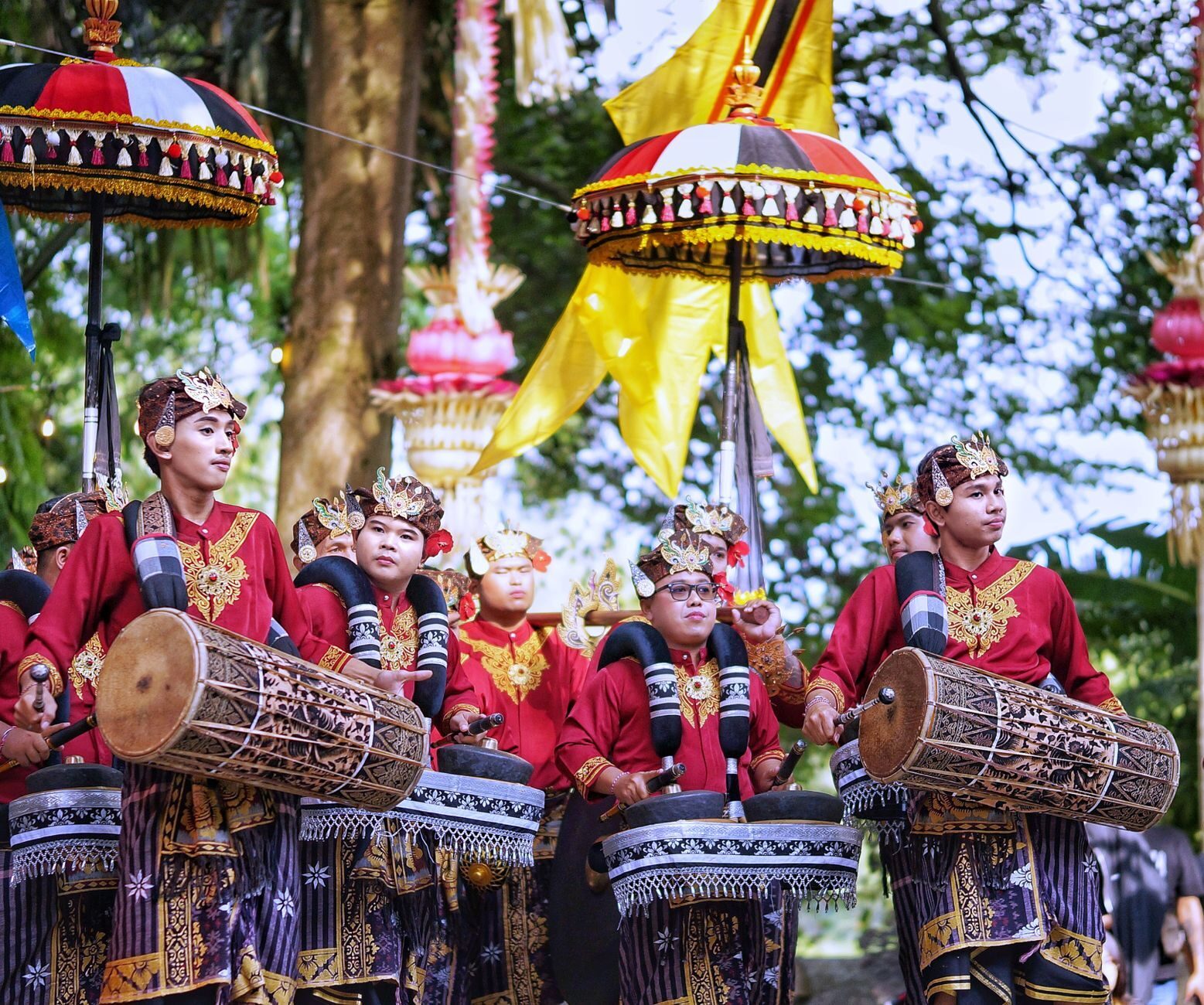 Drummers and cymbal players driving a gamelan procession.