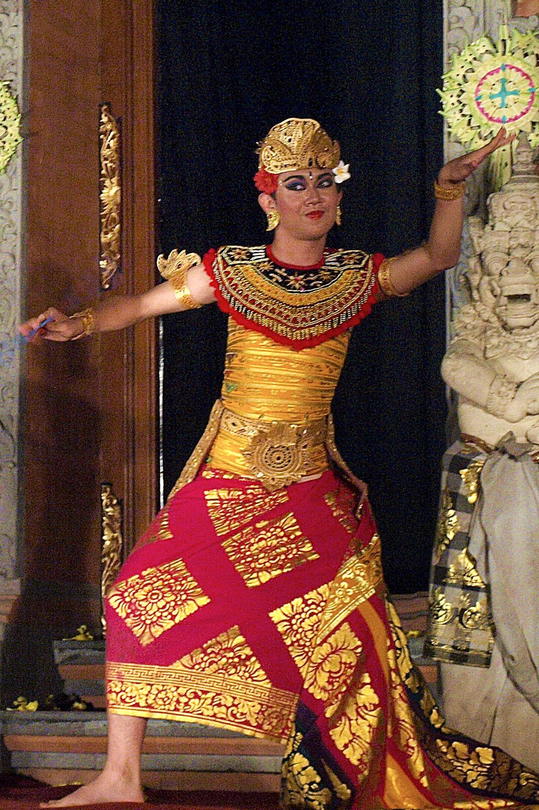 A Legong dancer with fan, mid-figure.