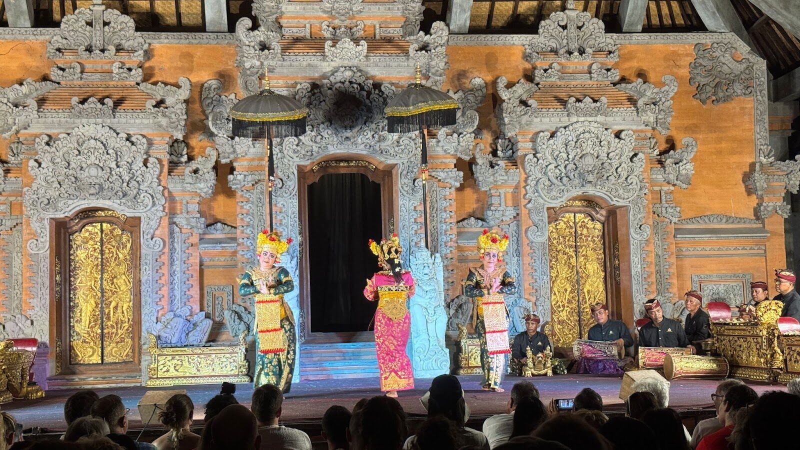 Dancers on a carved courtyard stage — the classic Ubud evening show.