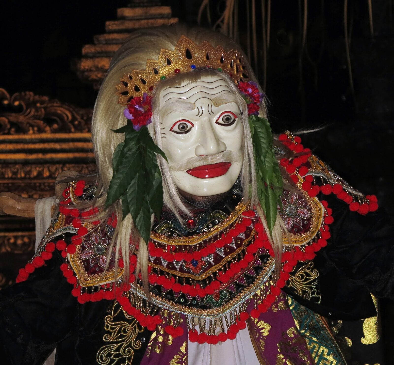 A masked Balinese dancer in full costume — the topeng tradition.