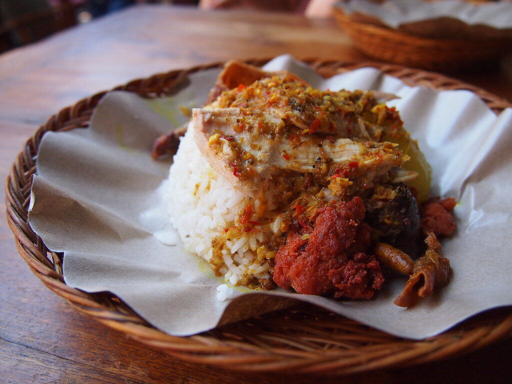 Babi guling — spit-roasted suckling pig with crackling skin, served over rice. The island's great feast dish.