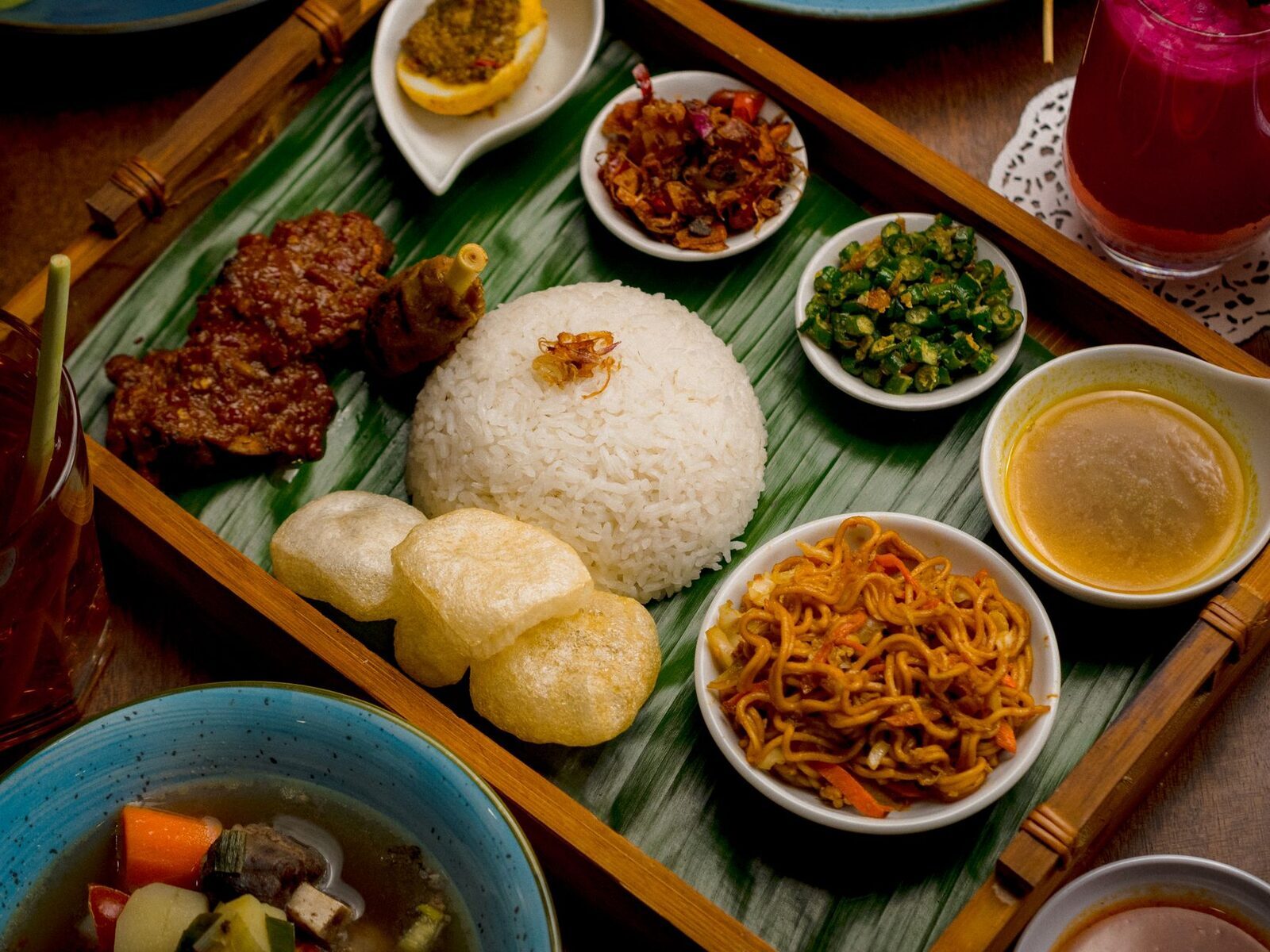 A full Balinese spread, each little dish leaning on the same fierce spice paste.