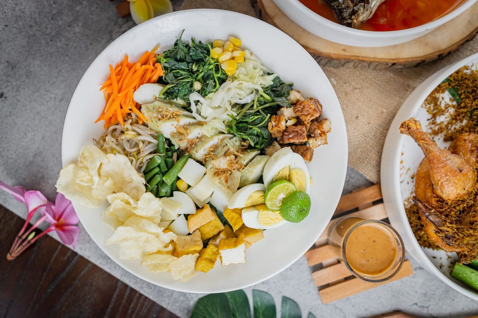 A vegetable-forward plate: greens, tofu and rice with sides.