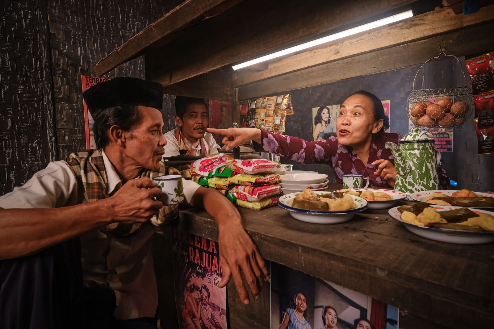 A family-run eatery at mealtime, plates passed across a worn counter.