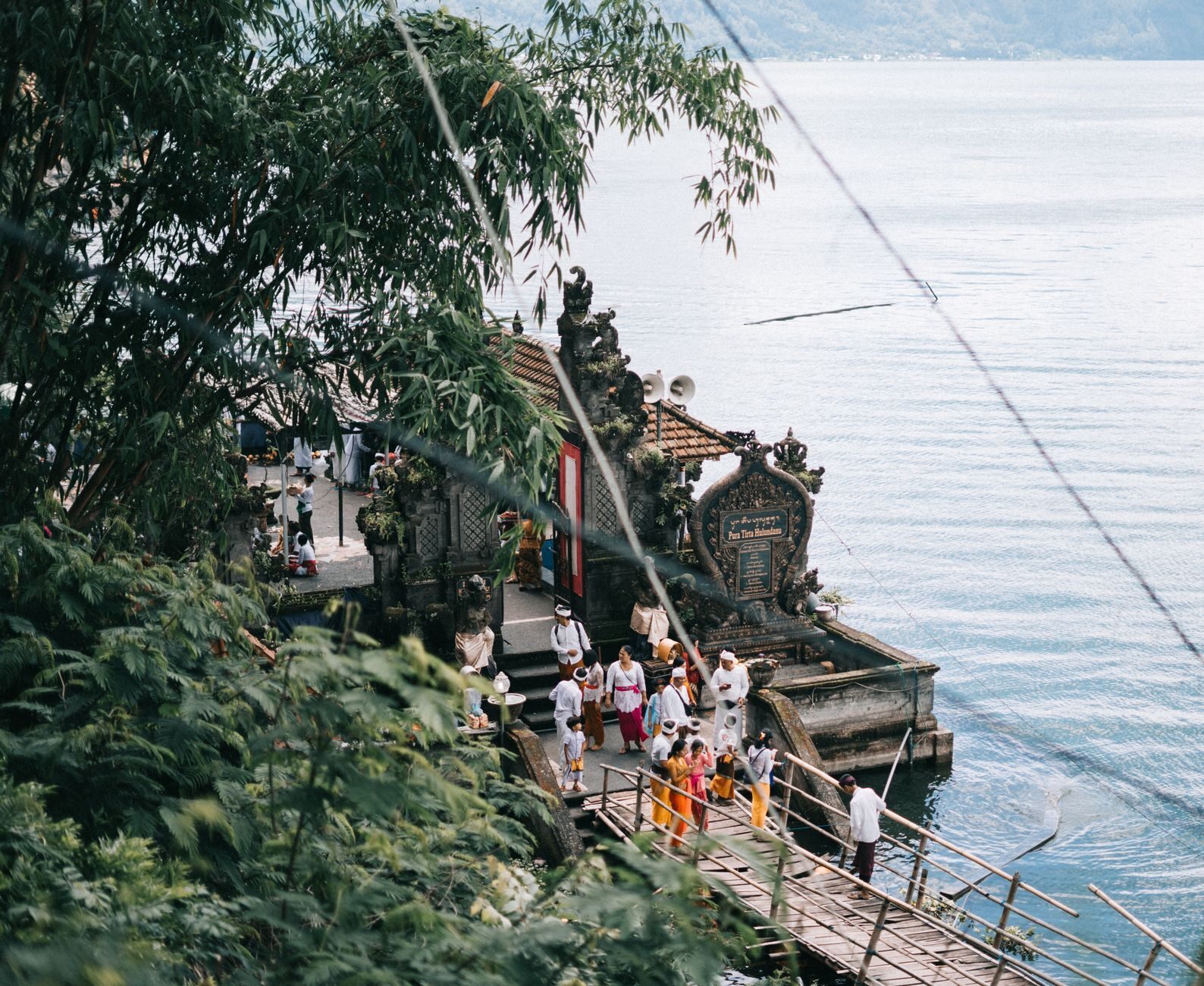 A highland lake temple gathered at the water's edge beneath the mountains.