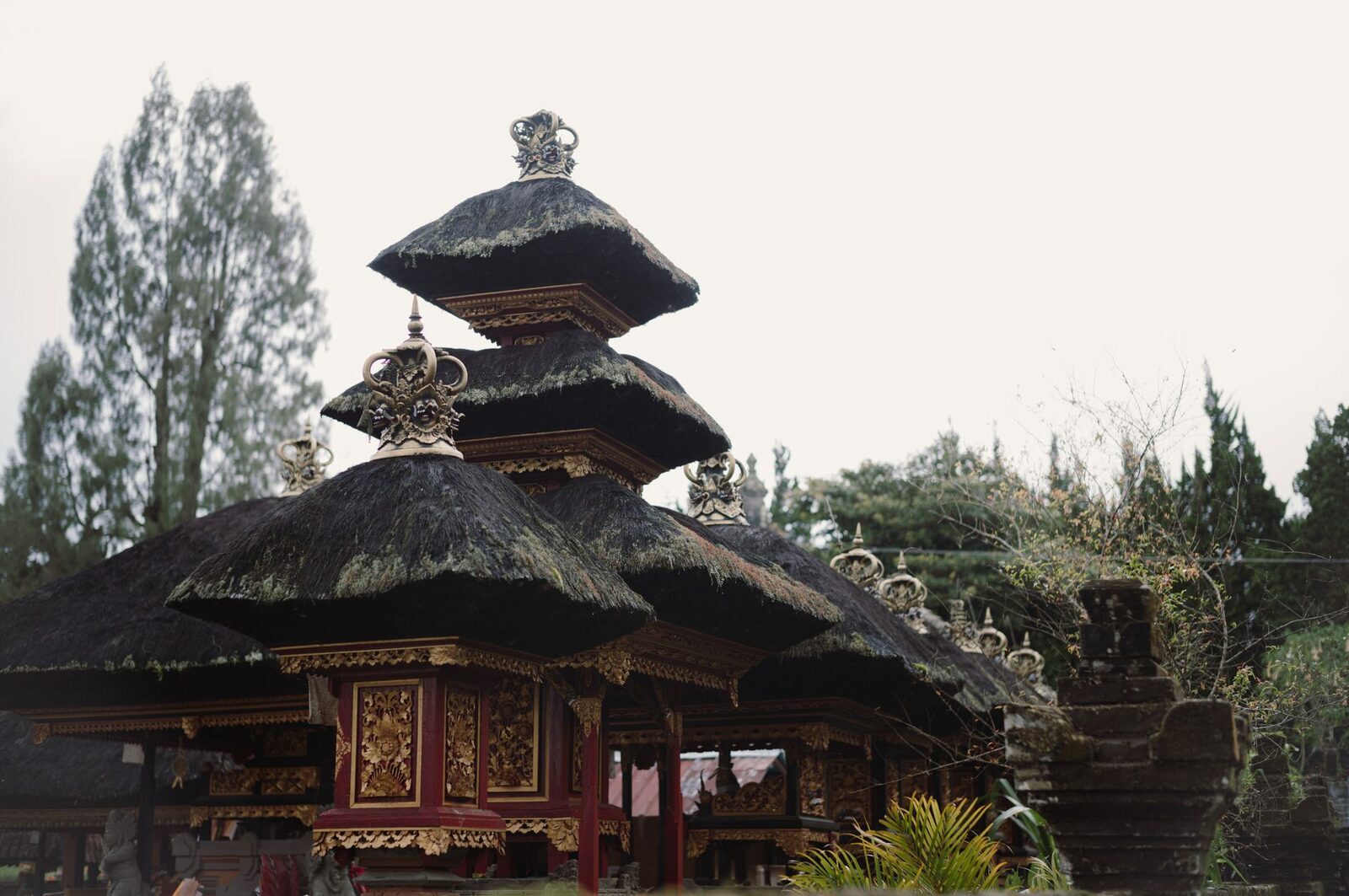 The tiered meru shrine, its stacked thatched roofs echoing the mountain that anchors the pure pole of the Balinese compass.