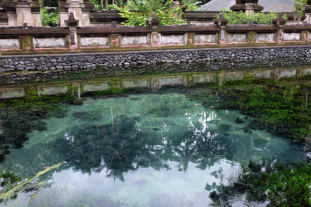 The clear spring pool where the water wells up — the reason a temple was built on this spot.