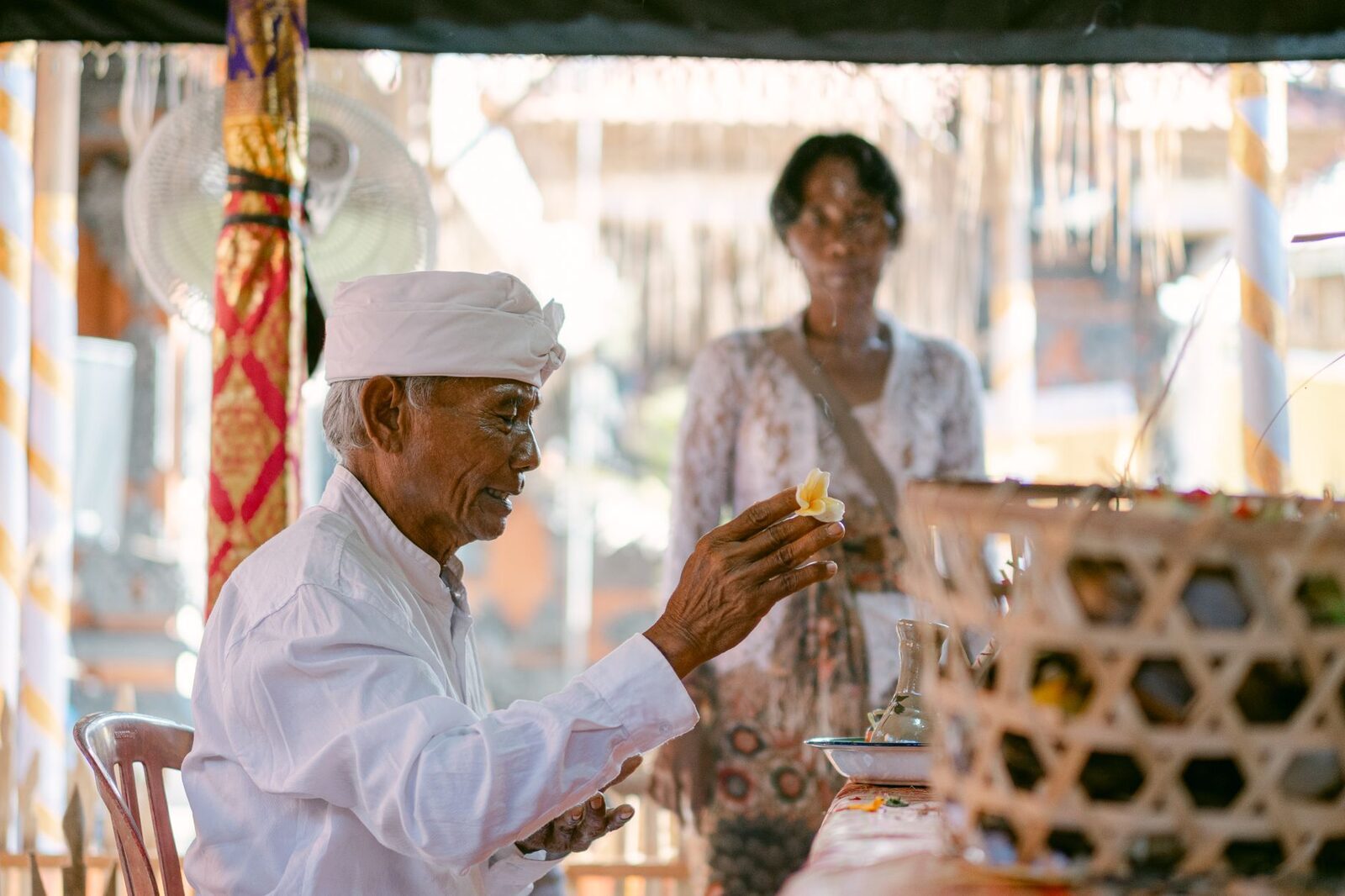 A pemangku — one of the lay temple priests who keep the daily rites — at his work.