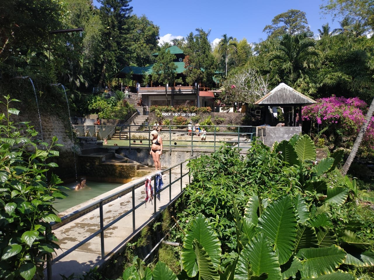 The tiered pools linked by a little bridge, jungle and frangipani closing in overhead.