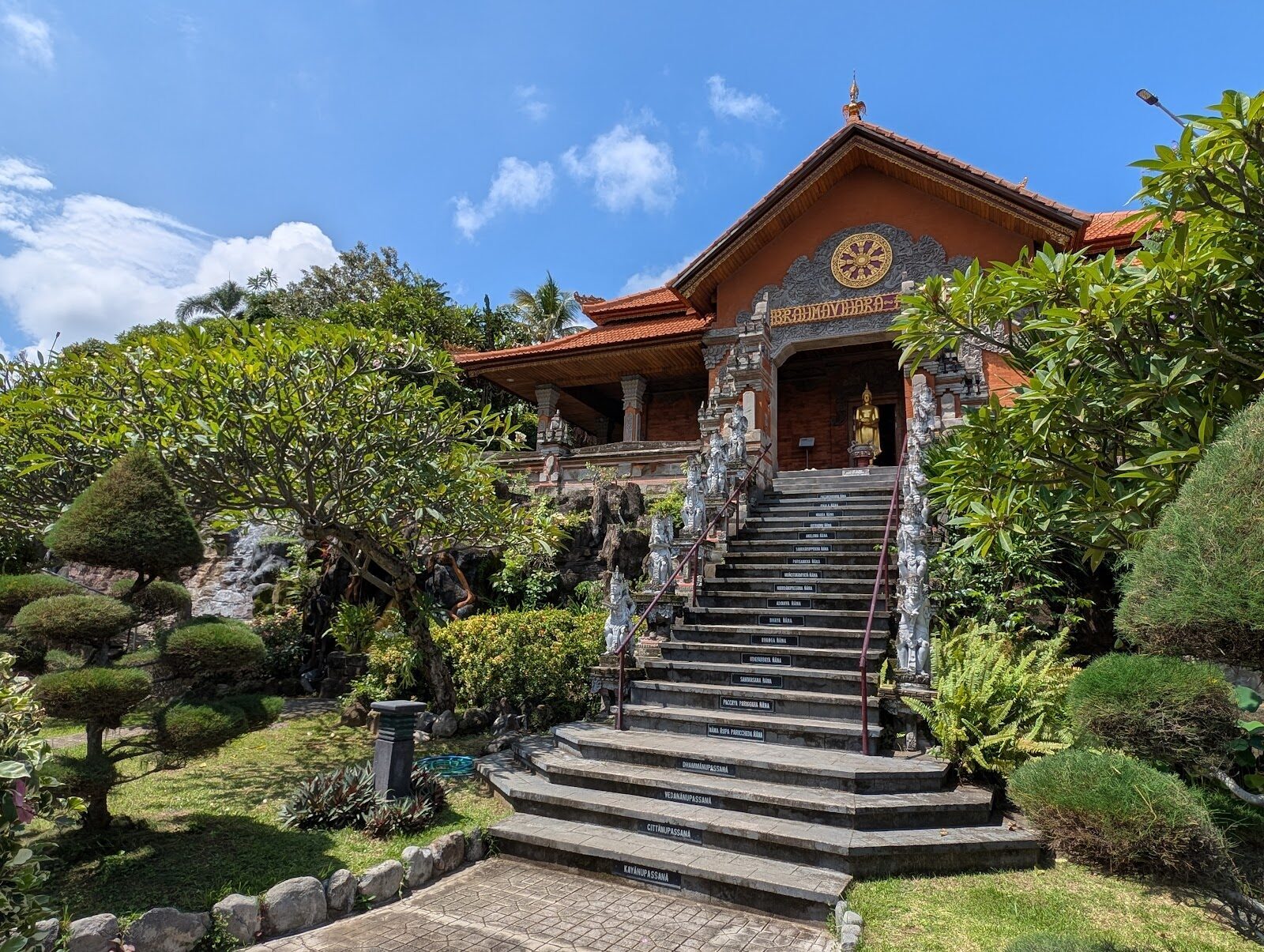 One of the monastery's orange-roofed pavilions above a run of stone steps.