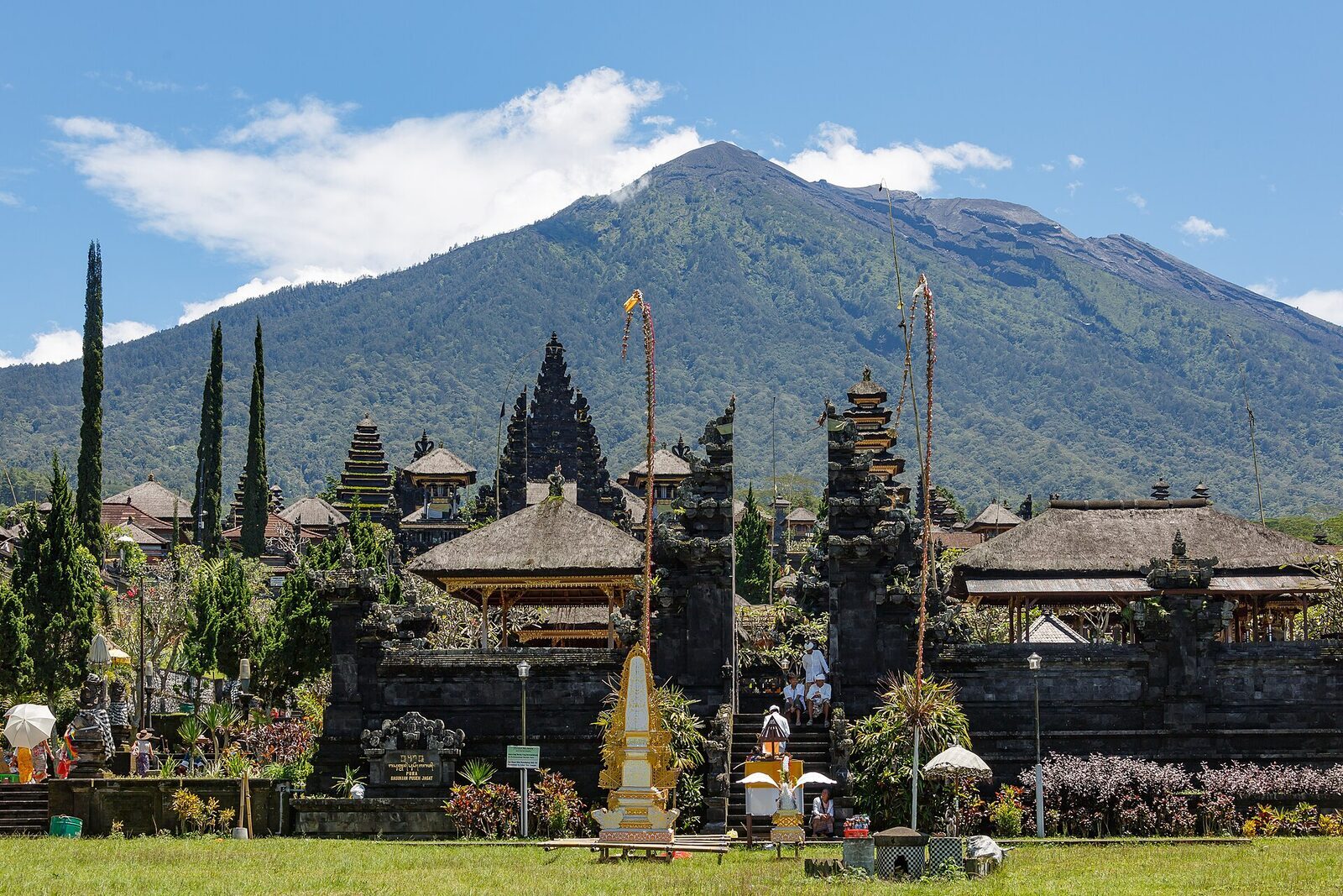 The temple pavilions with Agung's summit rising directly behind — on a clear morning the mountain dominates everything.