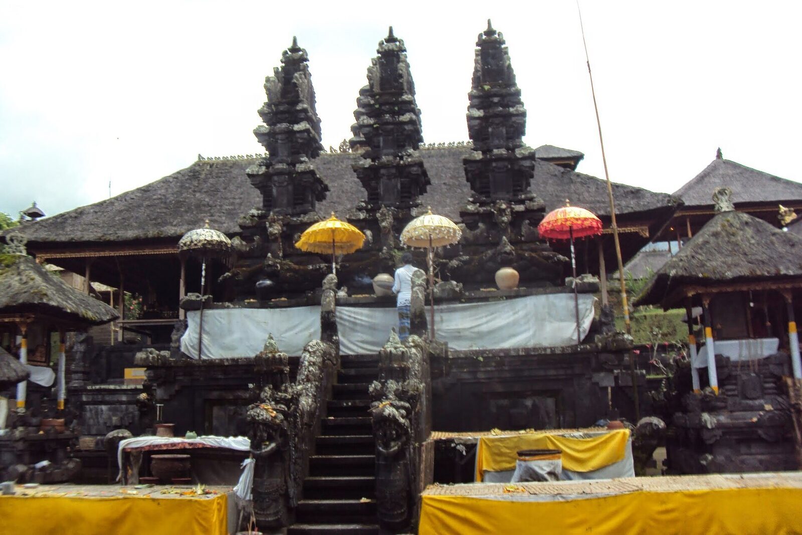 The stone stairway into an upper courtyard, shrines dressed in ceremonial yellow.