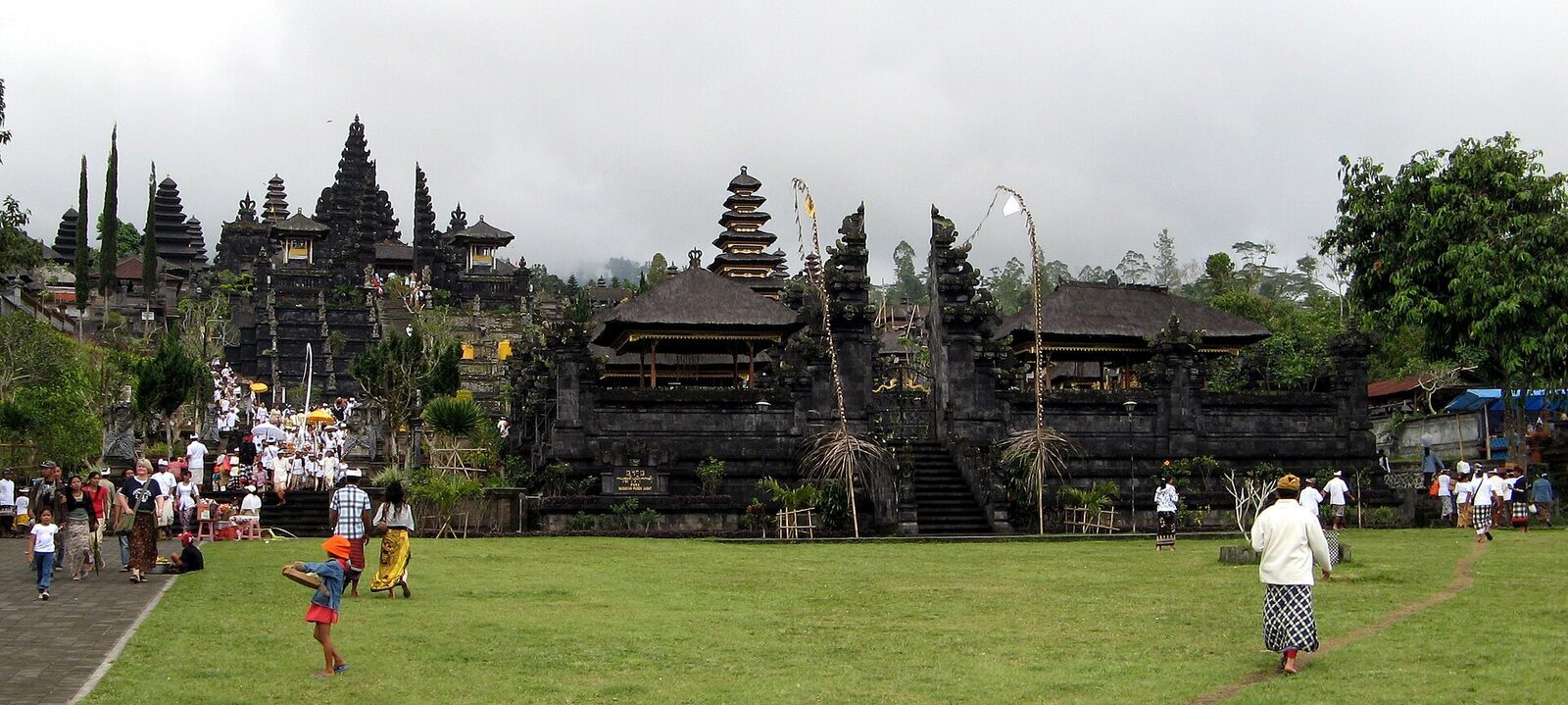 The classic wide view of Besakih — the split gate, the grand stair and the terraced temples climbing the flank of Mount Agung behind.