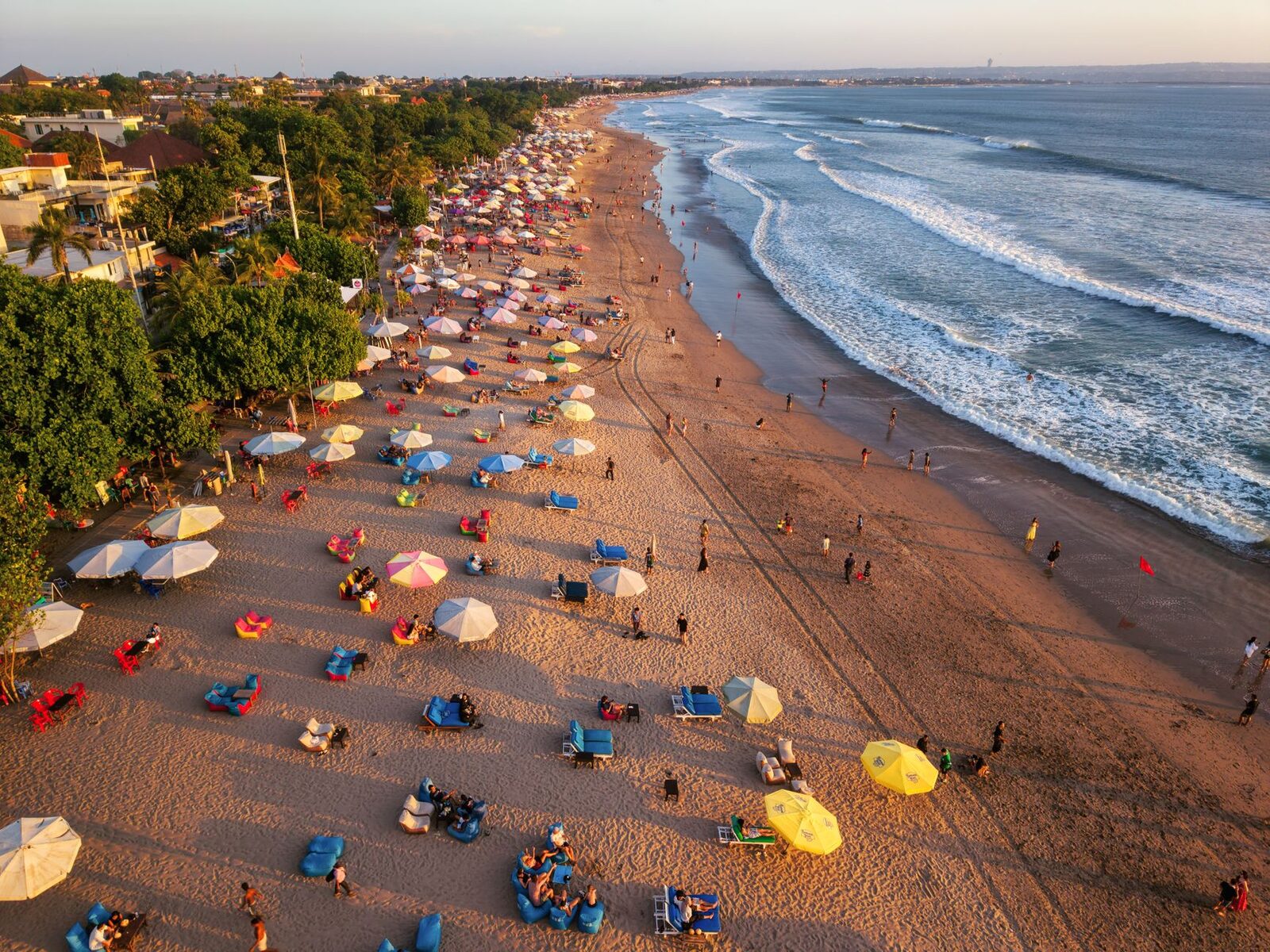 Sun loungers and umbrellas covering the sand from the air, the busy end of the island.