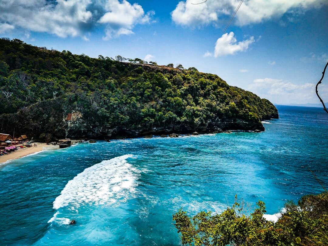 A sunlit turquoise cove under blue sky — the weather the dry months are famous for.