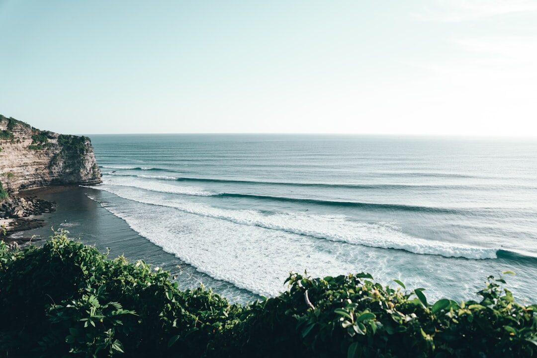 Dry-season Bali: a clean, glassy wave peeling under a bright sky — the Bukit at its postcard best, May to September.