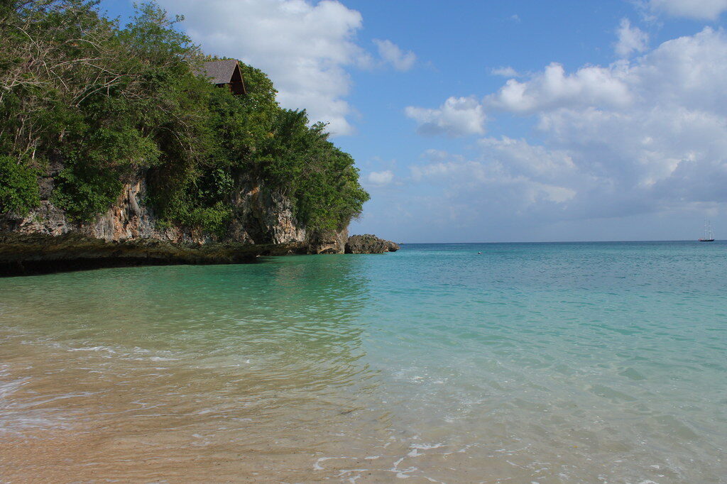 A calm, clear cove tucked below the cliffs.