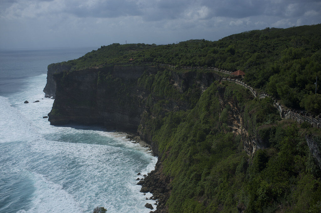 A dark headland and the open Indian Ocean off the Bukit's western edge.