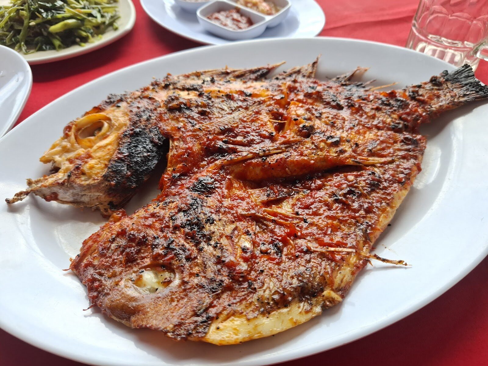 A whole fish grilled with sambal — the Jimbaran house style.