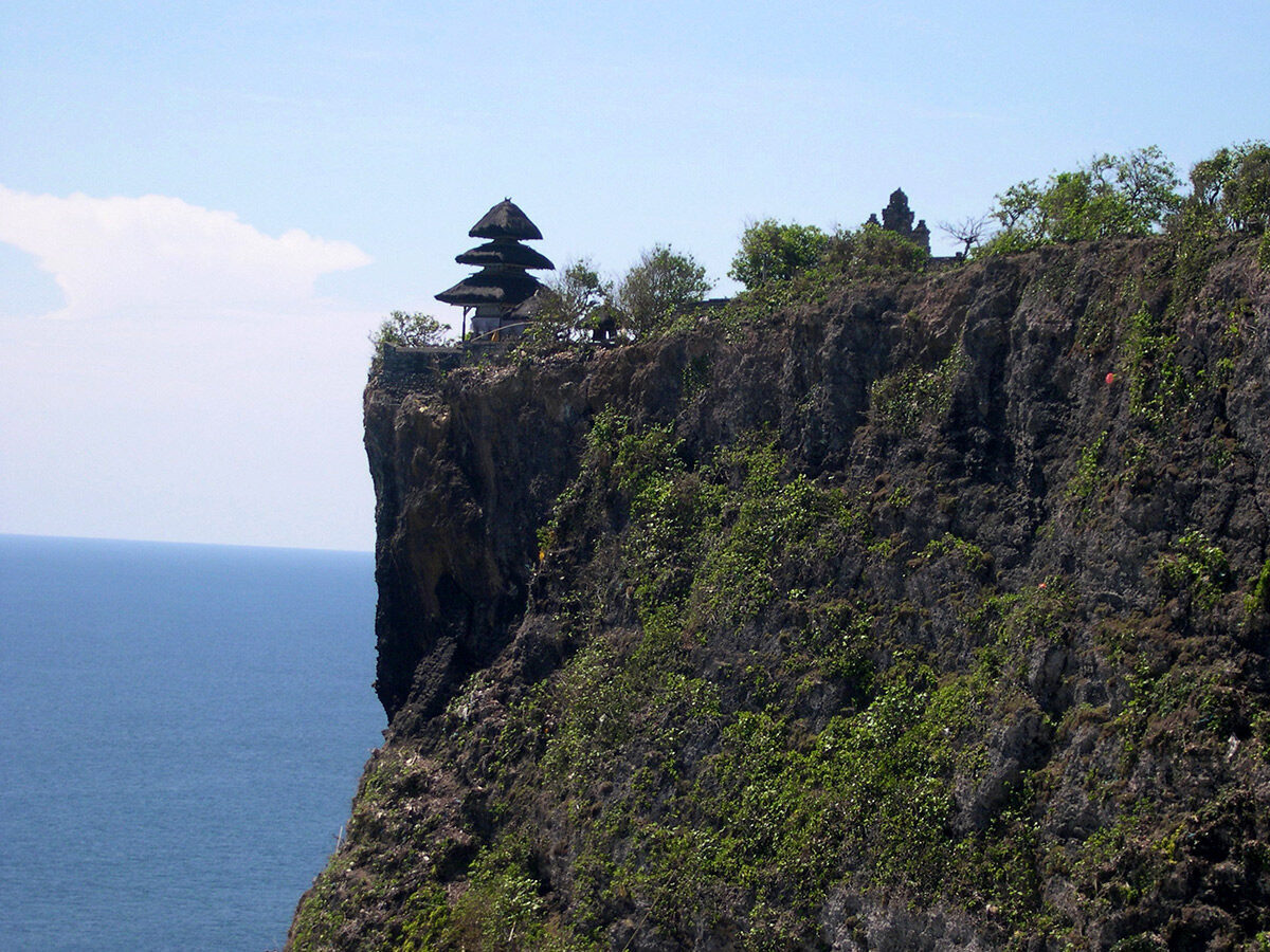 A tiered meru shrine set right on the lip of the cliff.