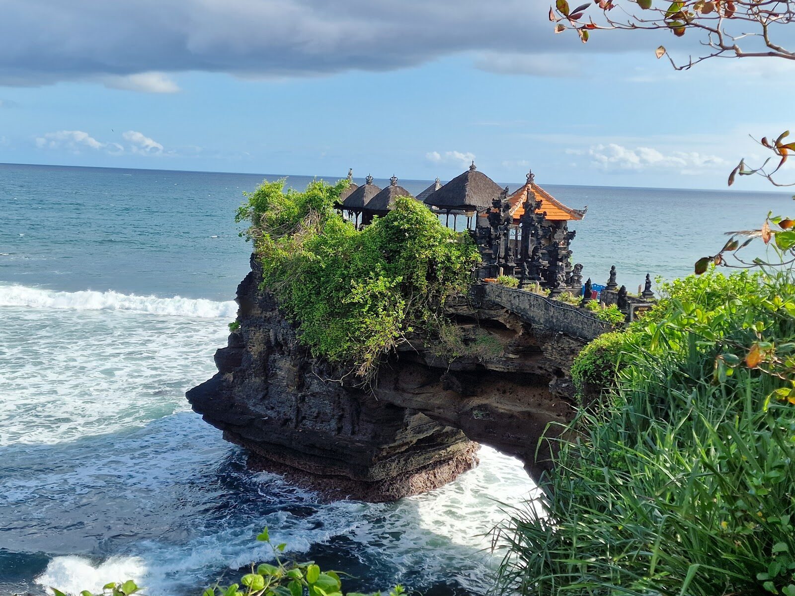 Batu Bolong — the smaller arched sea temple a short walk along the same coast.