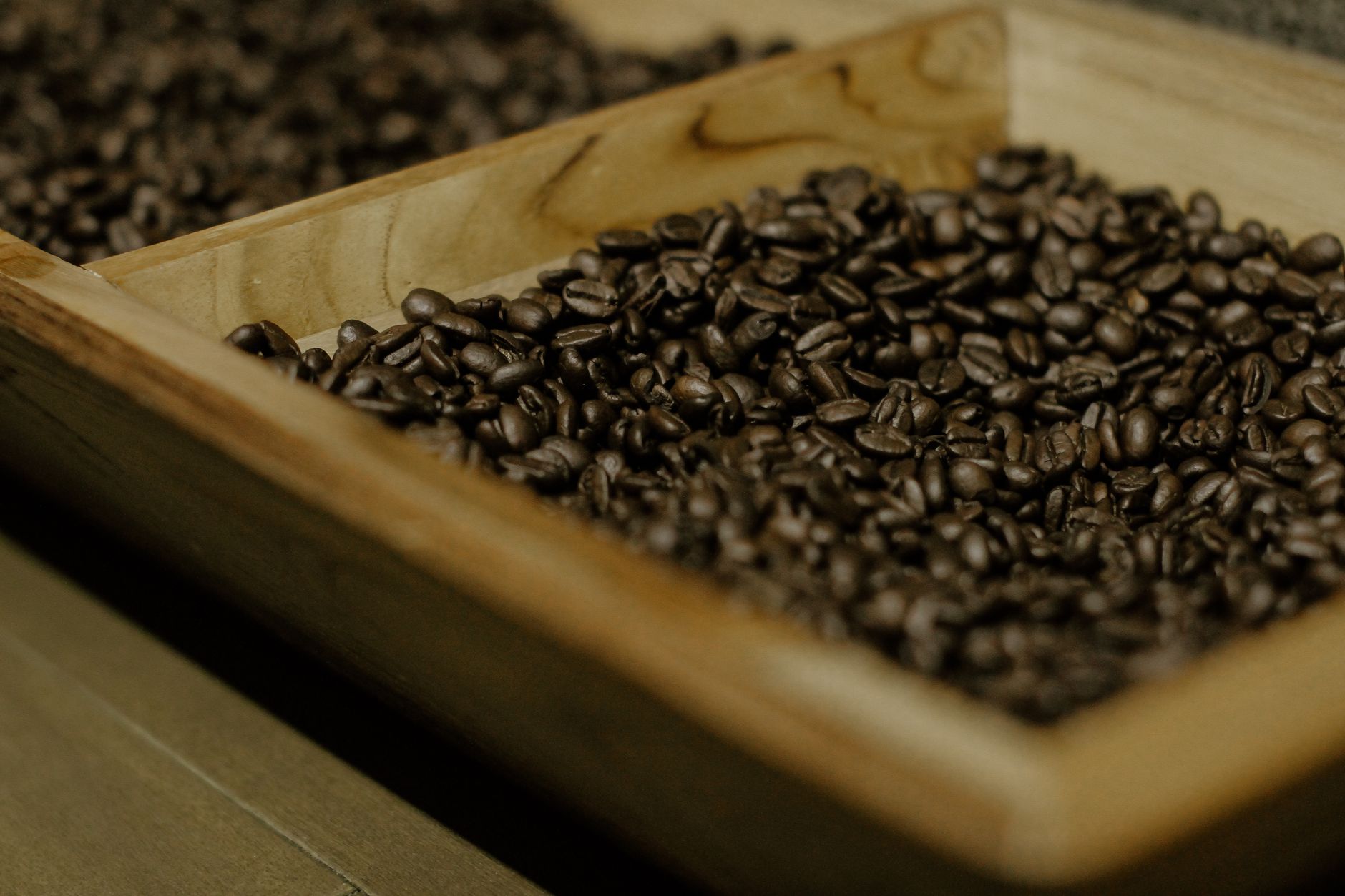 Roasted coffee beans in a wooden container