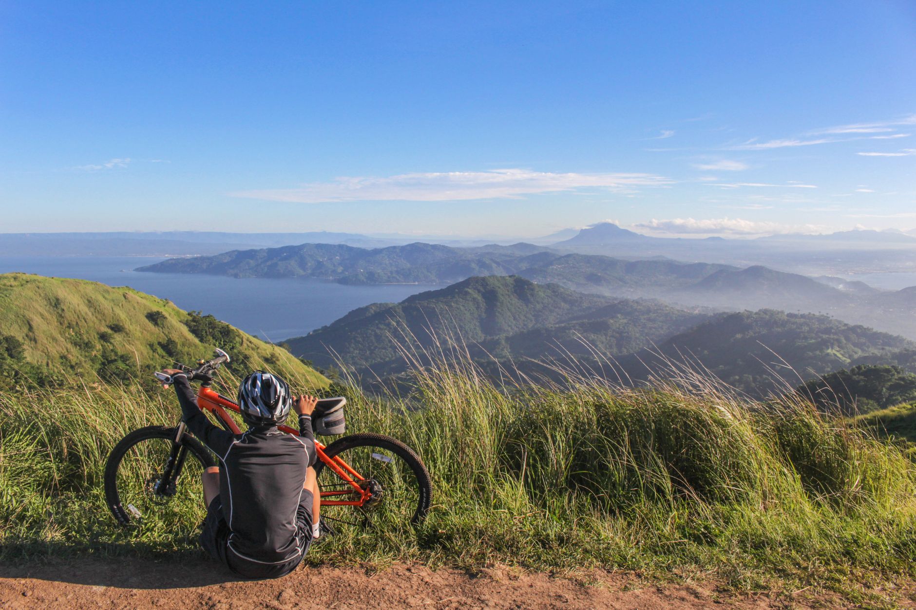 A bike-packer resting at a highland viewpoint over the sea