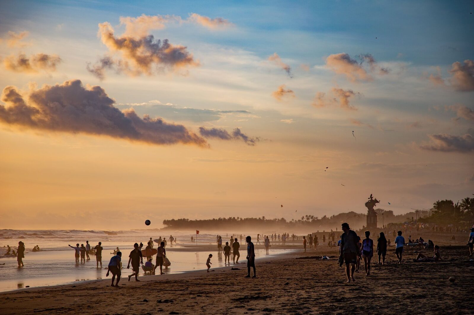 The beach at sunset, Canggu's evening gathering — surfers, sundowners and crowds.