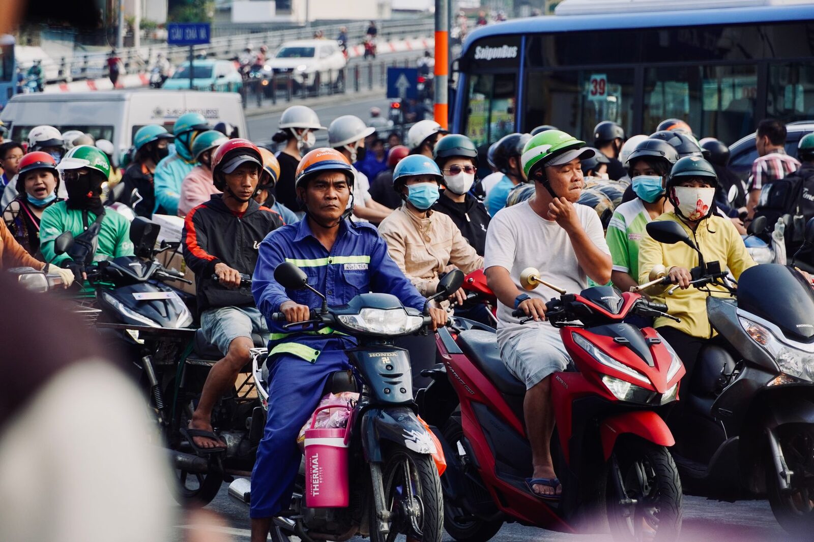 Helmets and masks in a packed junction — rush hour, Bali-style.